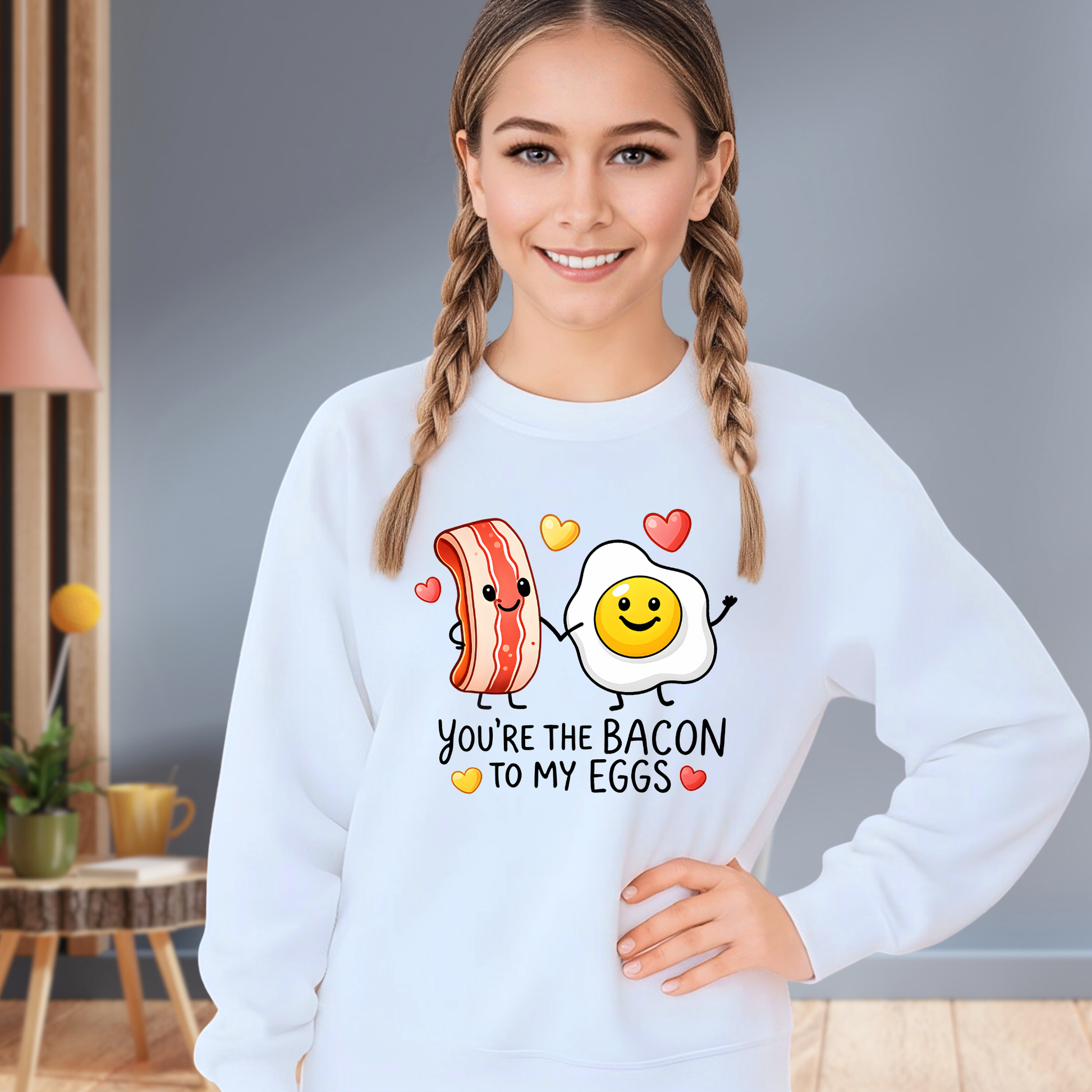 youth girl wearing white valentine sweatshirt with you’re the bacon to my eggs design