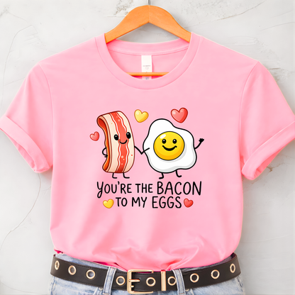 pink youth valentine t shirt on hanger featuring you’re the bacon to my eggs graphic