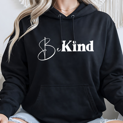 Black hoodie with 'Be Kind' text worn by a person indoors.