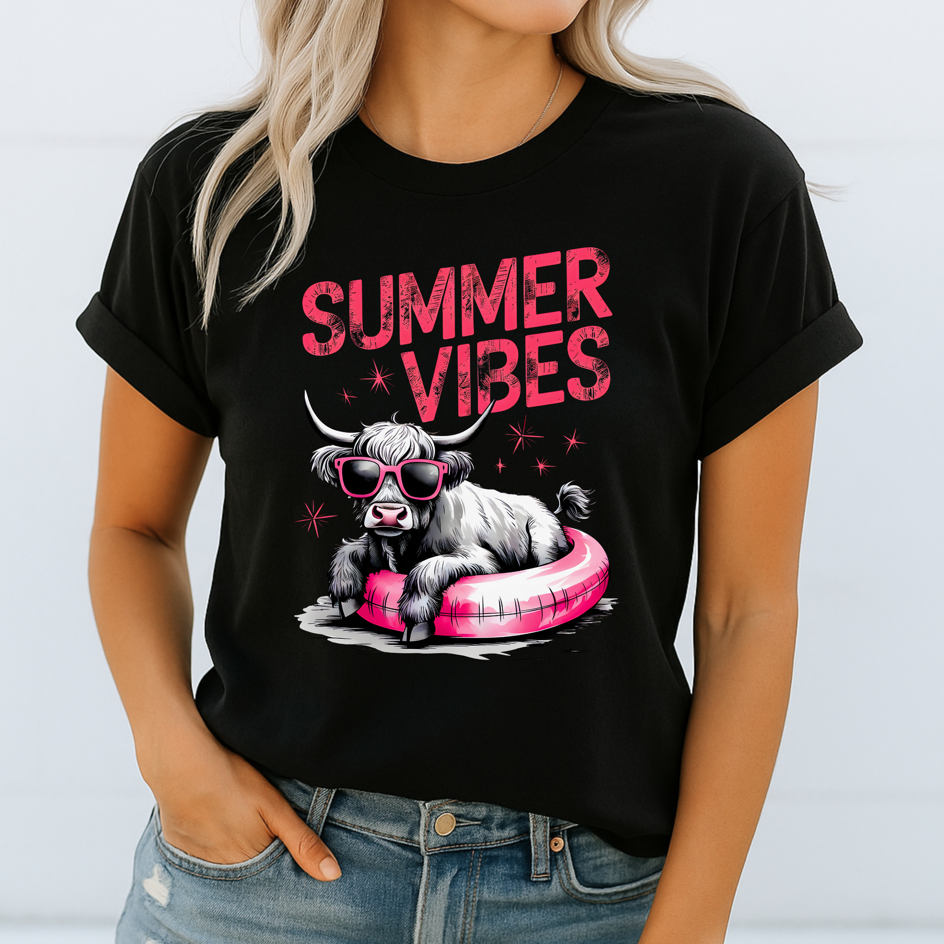 Black t-shirt with bold pink design and lounging cow
