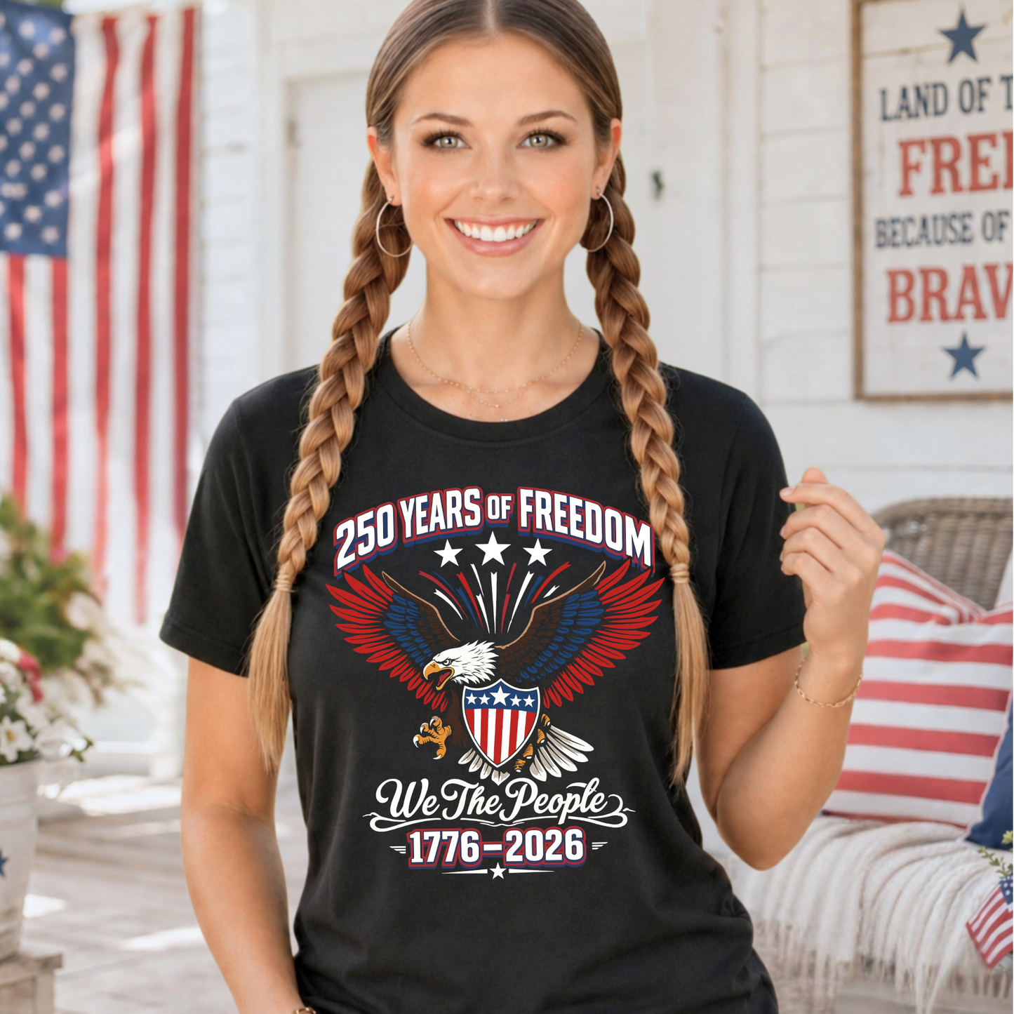 Woman wearing a black t-shirt with an eagle design and text "250 years of freedom", standing in front of an American flag.
