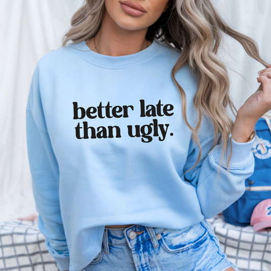 oman wearing light blue “Better Late Than Ugly” sweatshirt styled with distressed denim shorts. Trendy teen and women’s pullover perfect for casual outfits, school, or social media selfies. Unisex fit with cozy comfort and bold attitude.