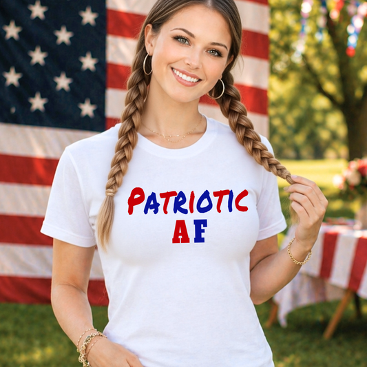 Woman wearing a white t-shirt with 'Patriotic AF' text in front of an American flag.