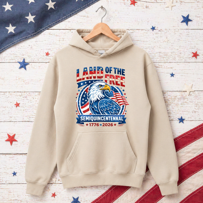 Beige hoodie with American flag and eagle design on a wooden background with stars and stripes.