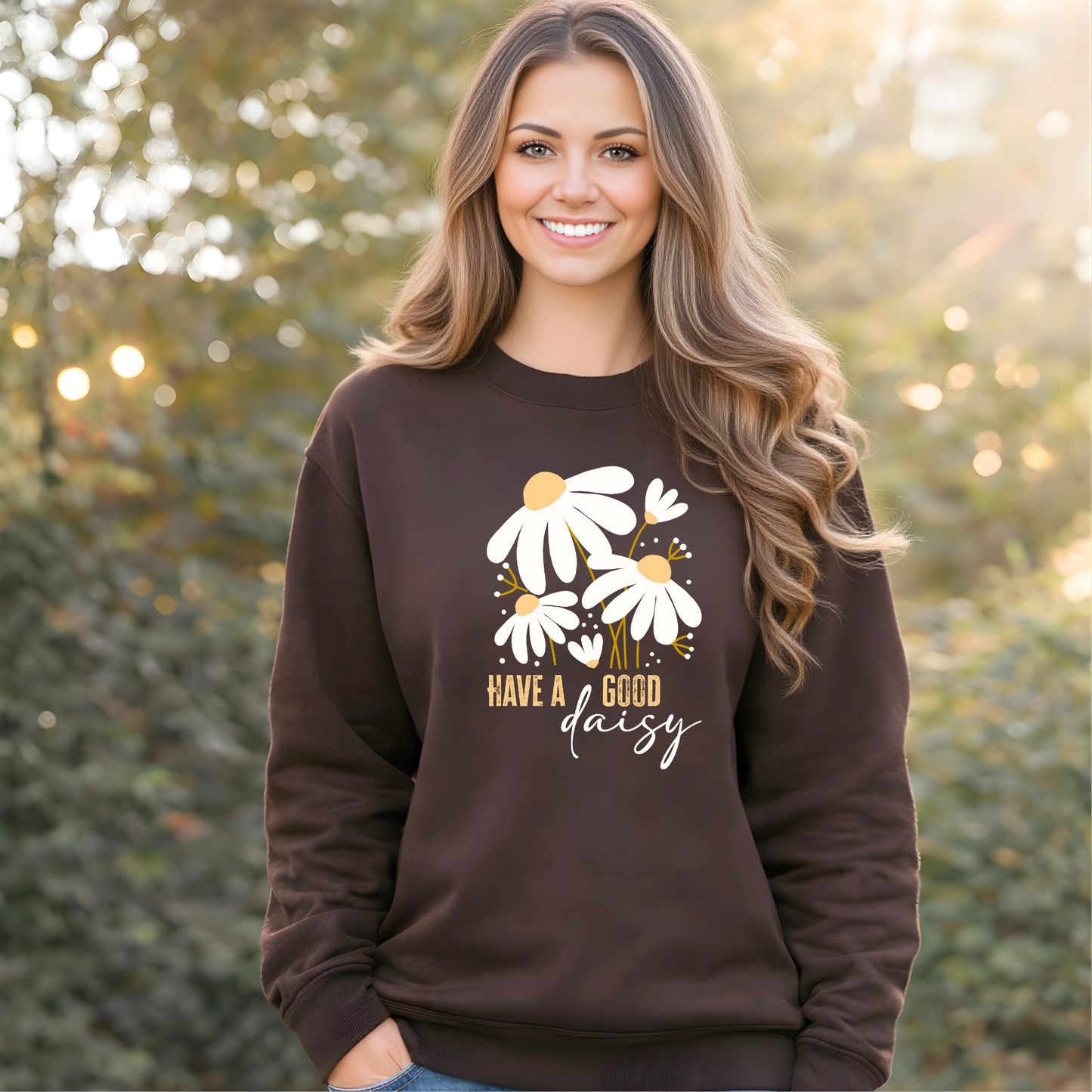 Woman wearing a brown sweatshirt with floral design and text, standing outdoors.
