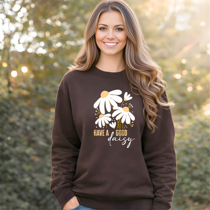 Woman wearing a brown sweatshirt with floral design and text, standing outdoors.