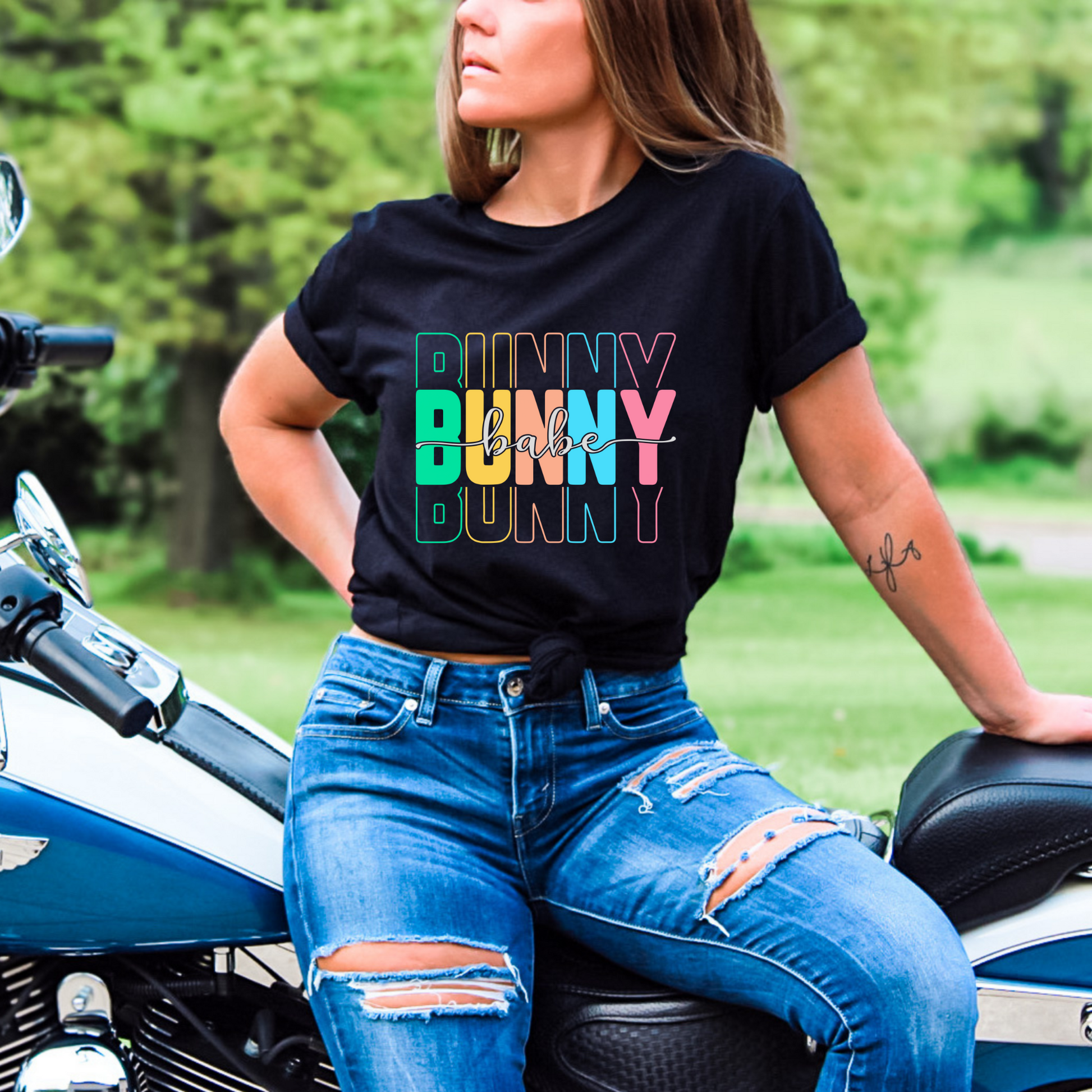 Trendy Bunny Babe graphic t-shirt with colorful pastel typography, perfect for Easter outfits, spring fashion, and casual wear. Soft cotton tee for women.