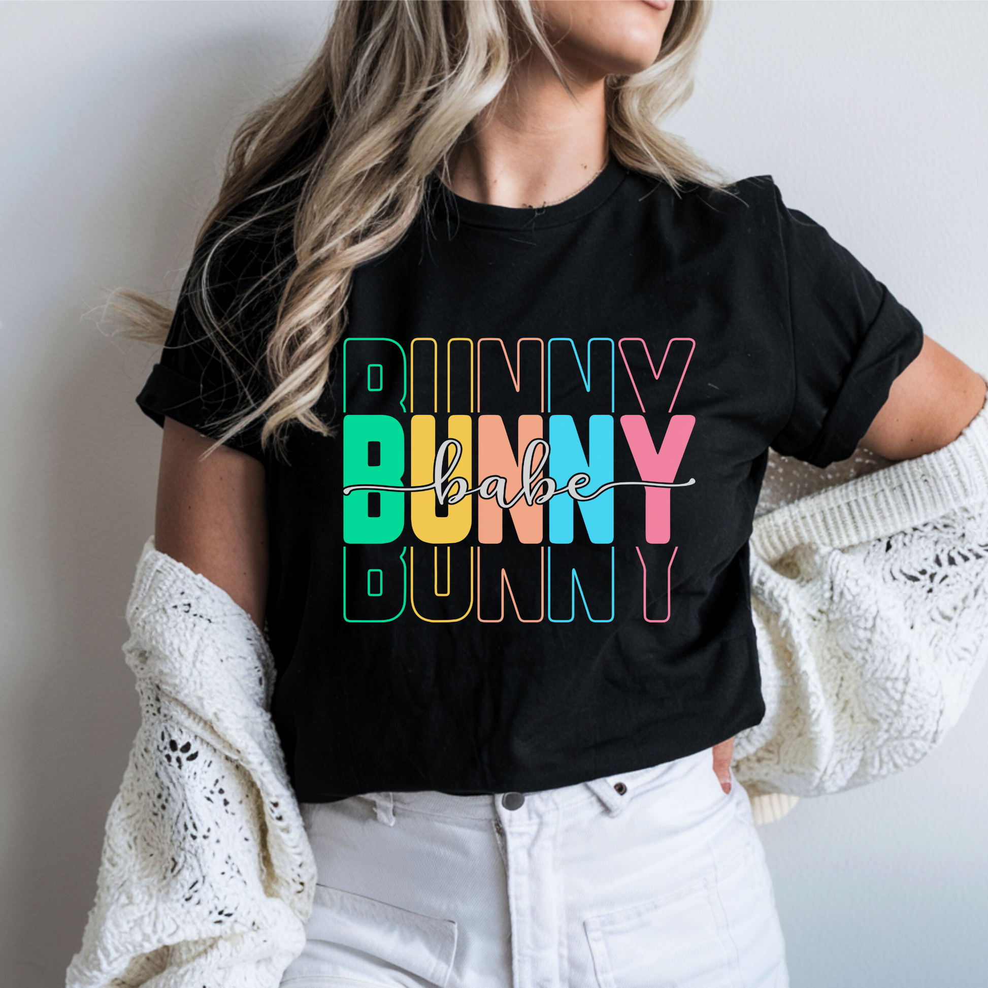 Trendy Bunny Babe graphic t-shirt with colorful pastel typography, perfect for Easter outfits, spring fashion, and casual wear. Soft cotton tee for women.