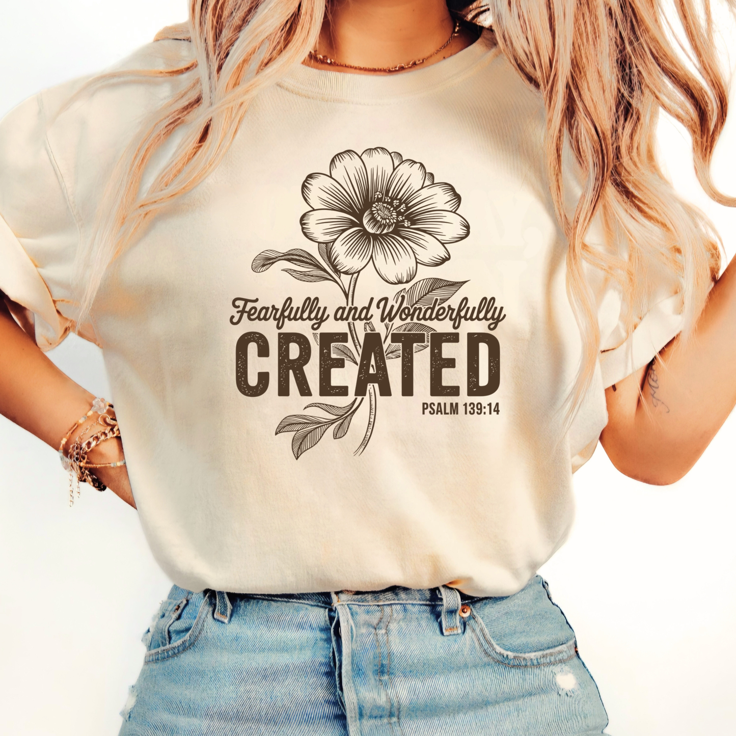 Brown hoodie with Fearfully and Wonderfully Created floral design worn indoors