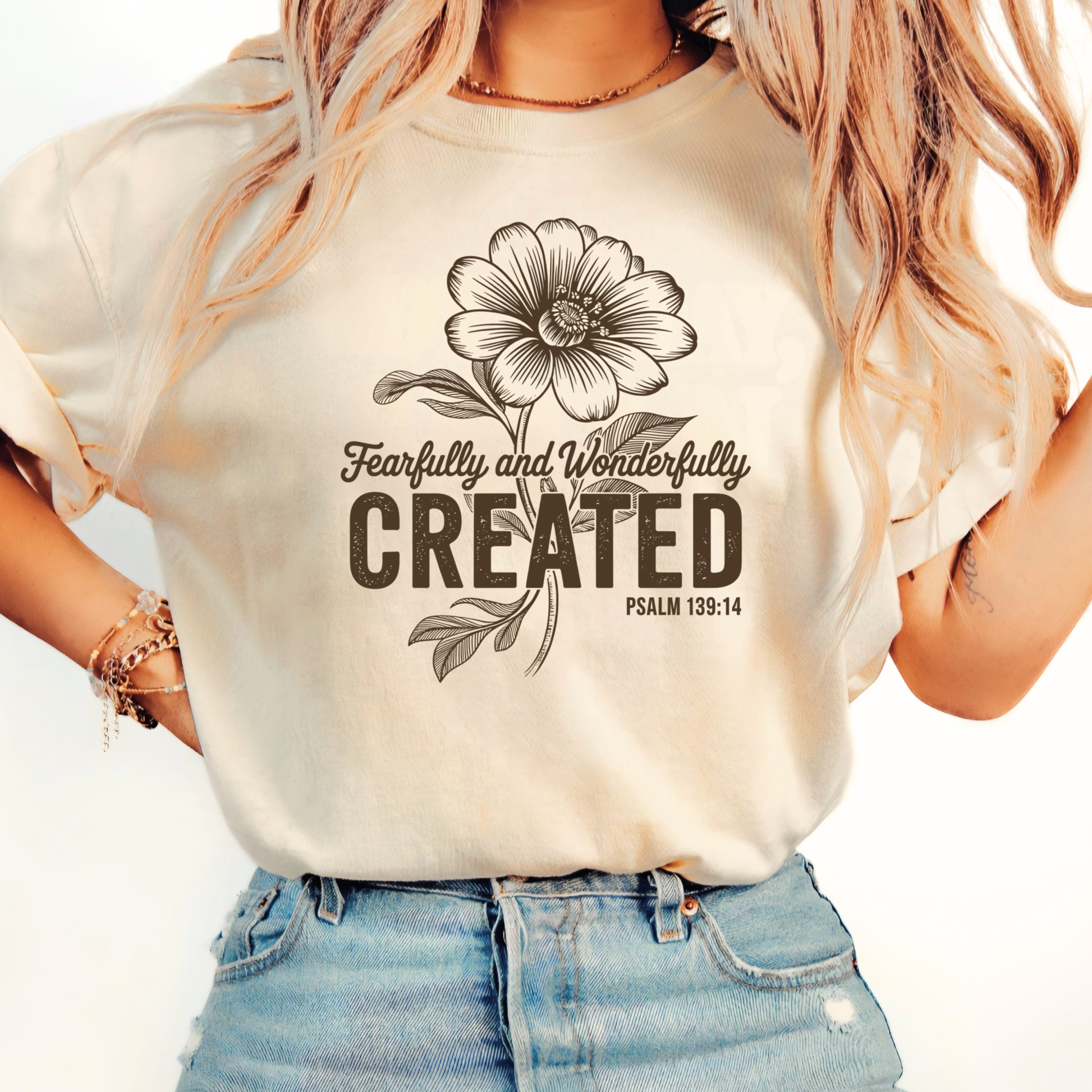 Brown hoodie with Fearfully and Wonderfully Created floral design worn indoors