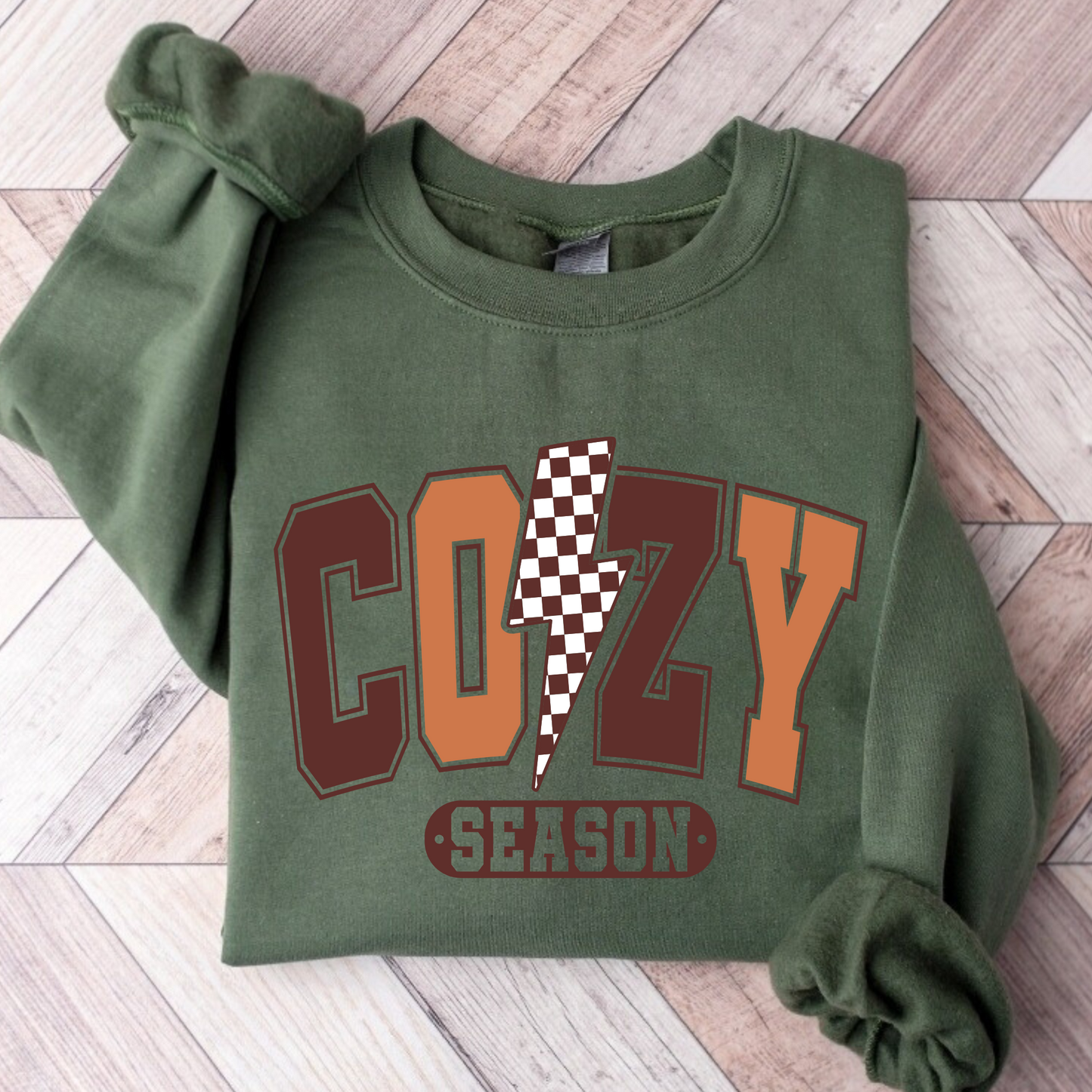Flat lay of military green COZY SEASON sweatshirt