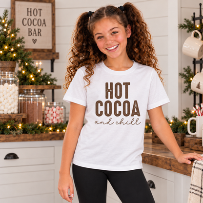 Youth girl wearing a white Hot Cocoa and Chill T-shirt at a decorated farmhouse hot cocoa bar