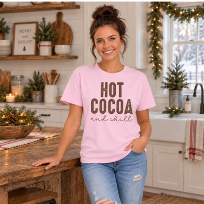 Woman wearing a pink Hot Cocoa and Chill T-shirt in a cozy farmhouse kitchen decorated for Christmas