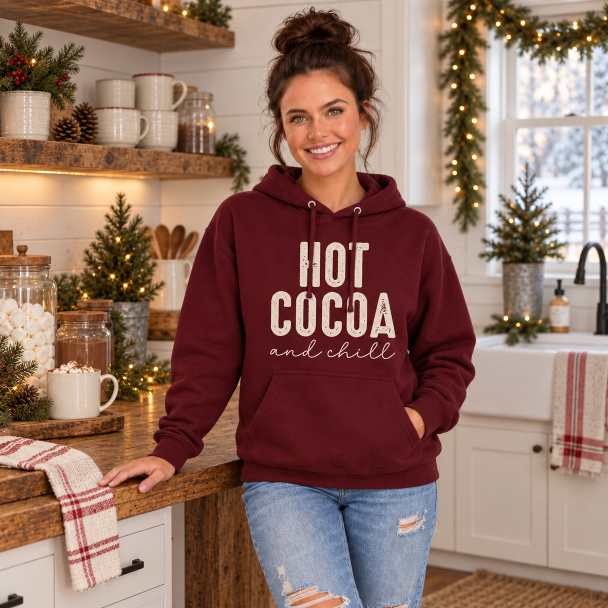 Woman wearing a maroon hoodie with Hot Cocoa and Chill design at a festive hot cocoa bar