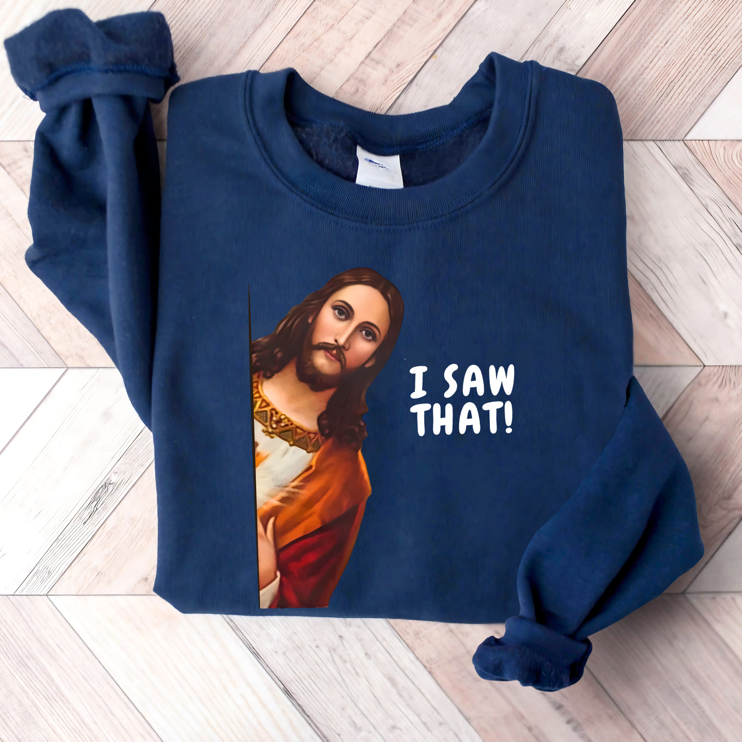 Navy blue sweatshirt flat lay Jesus I Saw That graphic, Christian humor apparel folded shirt lifestyle display
