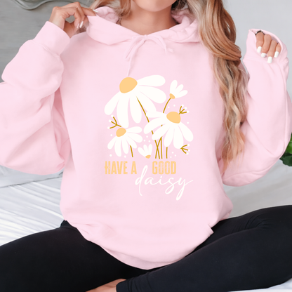 Woman wearing a pink hoodie with floral design and text "Have a Good Daisy: