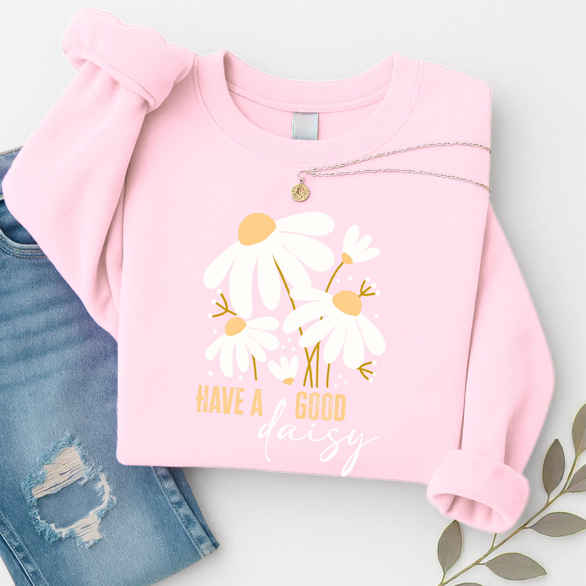 Pink sweatshirt with floral design and text on a light gray background