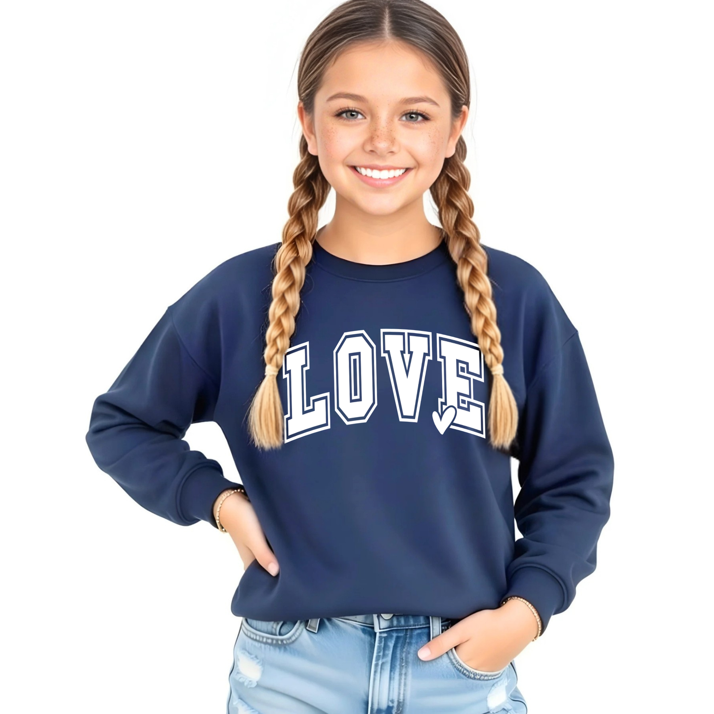 Youth girl wearing a navy blue LOVE graphic crewneck sweatshirt with white varsity lettering and light wash denim shorts