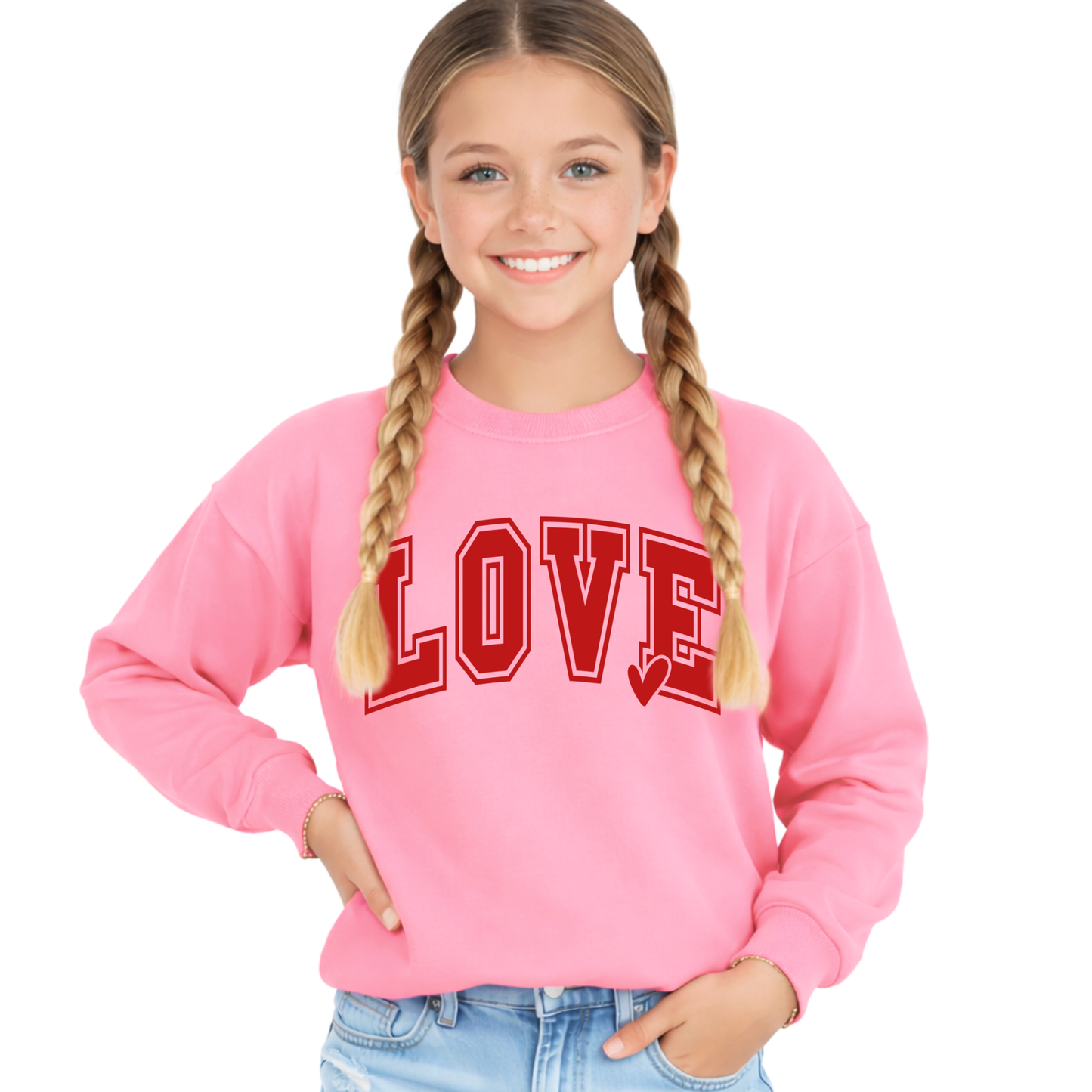 Youth girls pink LOVE sweatshirt with bold red varsity font and heart detail, cozy long sleeve pullover, styled with jeans, front view, cute kids Valentine outfit
