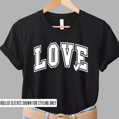 Black LOVE graphic youth t-shirt with white varsity lettering and heart detail, displayed on hanger, casual kids clothing, trendy Valentine shirt for girls