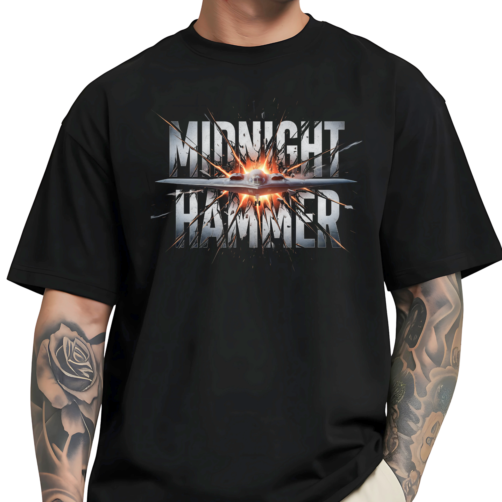 Oversized Midnight Hammer stealth bomber graphic tee on male model – black shirt with silver text and fire burst