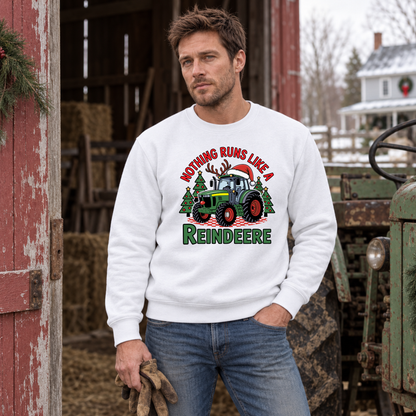 Man in a white Nothing Runs Like a Reindeere sweatshirt beside a red barn and vintage green tractor.