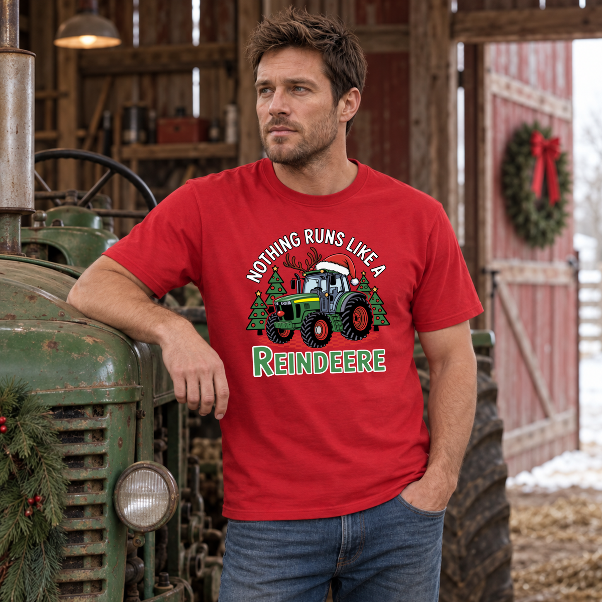 Man wearing a red Nothing Runs Like a Reindeere T-shirt leaning on a vintage green tractor inside a barn.