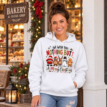 Woman wearing a white hoodie with We Wish You Nothing Butt a Merry Christmas design with rear-view Santa, bear, reindeer, snowman and gingerbread characters outside a festive bakery