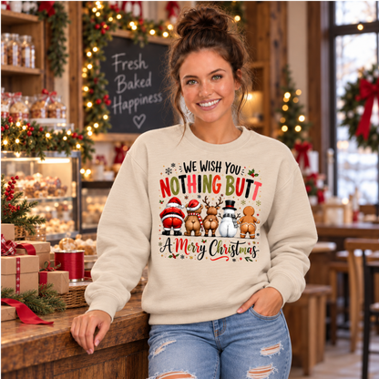 Woman wearing a sand crewneck sweatshirt with We Wish You Nothing Butt a Merry Christmas design with rear-view Santa, bear, reindeer, snowman and gingerbread characters in a festive bakery