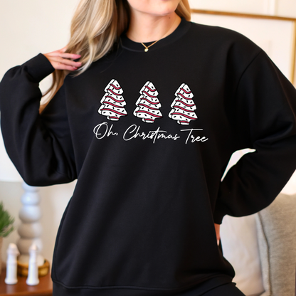 Woman wearing a black unisex Christmas sweatshirt with three red and white decorated trees and “Oh Christmas Tree” text. Cozy holiday pullover styled with casual jeans.