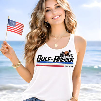 White women’s racerback tank top with Gulf of America graphic, worn by blonde model holding American flag on beach, close-up lifestyle mockup