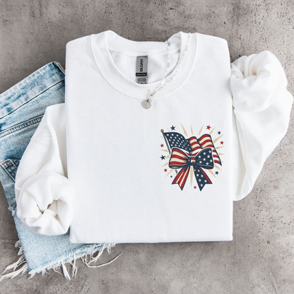White sweatshirt with American flag bow design on a concrete surface