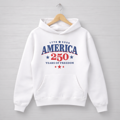 White hoodie with 'America 250 Years of Freedom' text on a wooden hanger against a light gray background