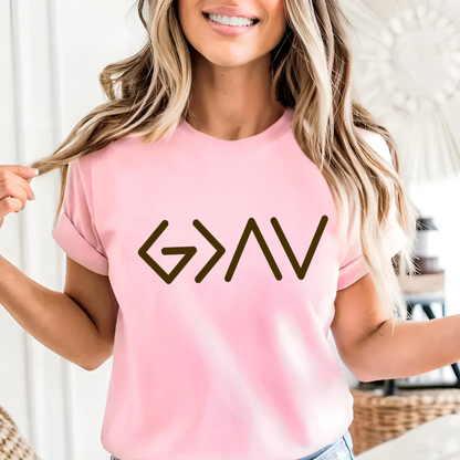 Pink short sleeve t-shirt worn by model featuring gold God Is Greater Than the Highs and Lows front design