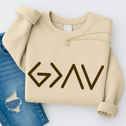 Light beige sweatshirt folded featuring gold God Is Greater Than the Highs and Lows front design