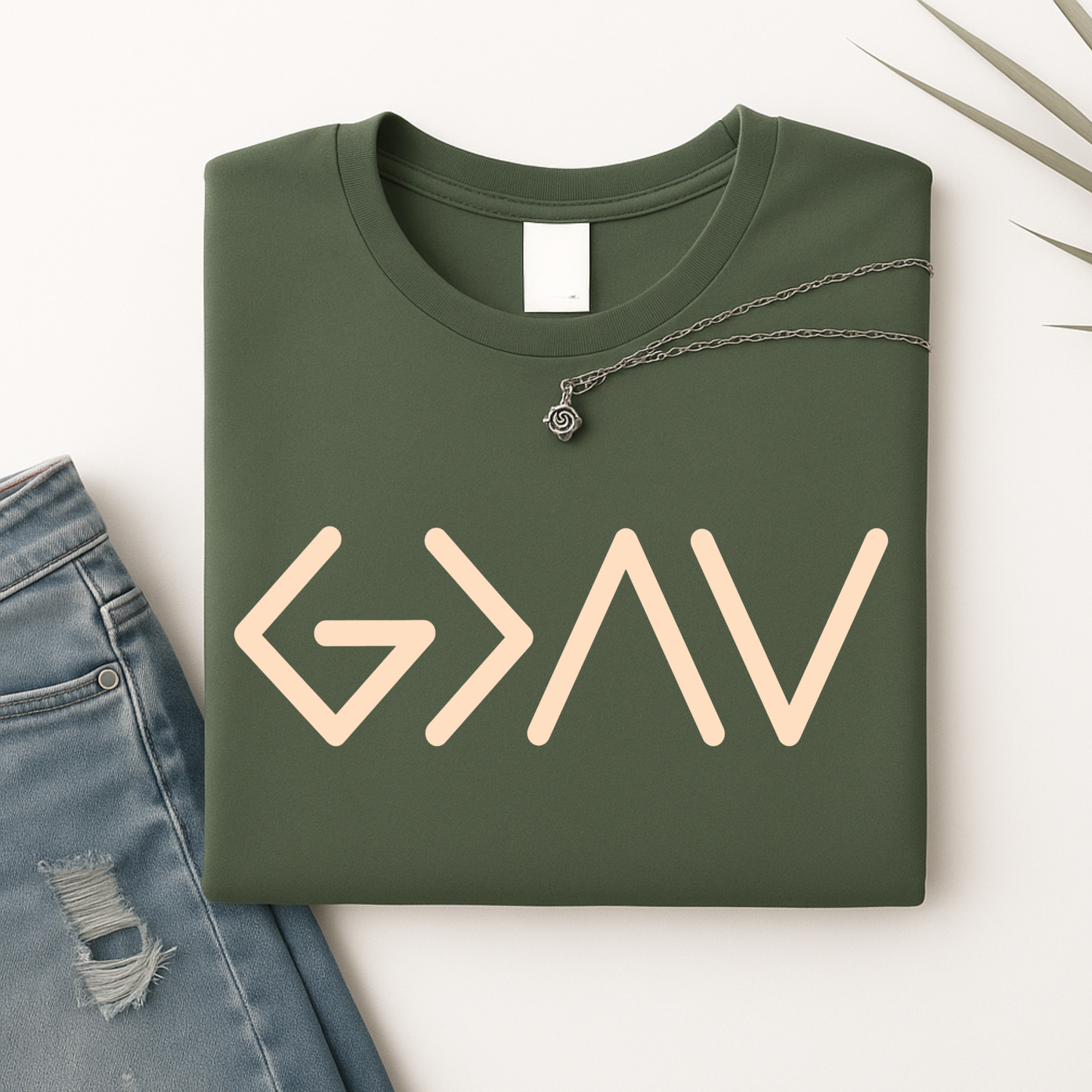 Dark green sweatshirt folded showing gold God Is Greater Than the Highs and Lows front design