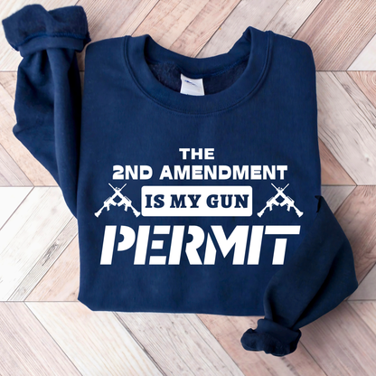 Navy blue sweatshirt with white text and graphics on a wooden floor.