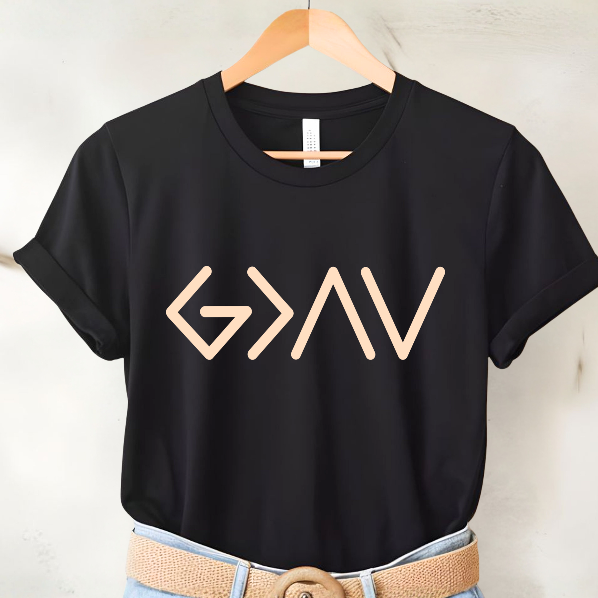 Black short sleeve t-shirt on hanger with gold God Is Greater Than the Highs and Lows front design