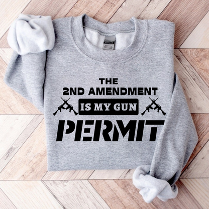 Gray sweatshirt with text 'The 2nd Amendment is my gun permit' on a wooden surface