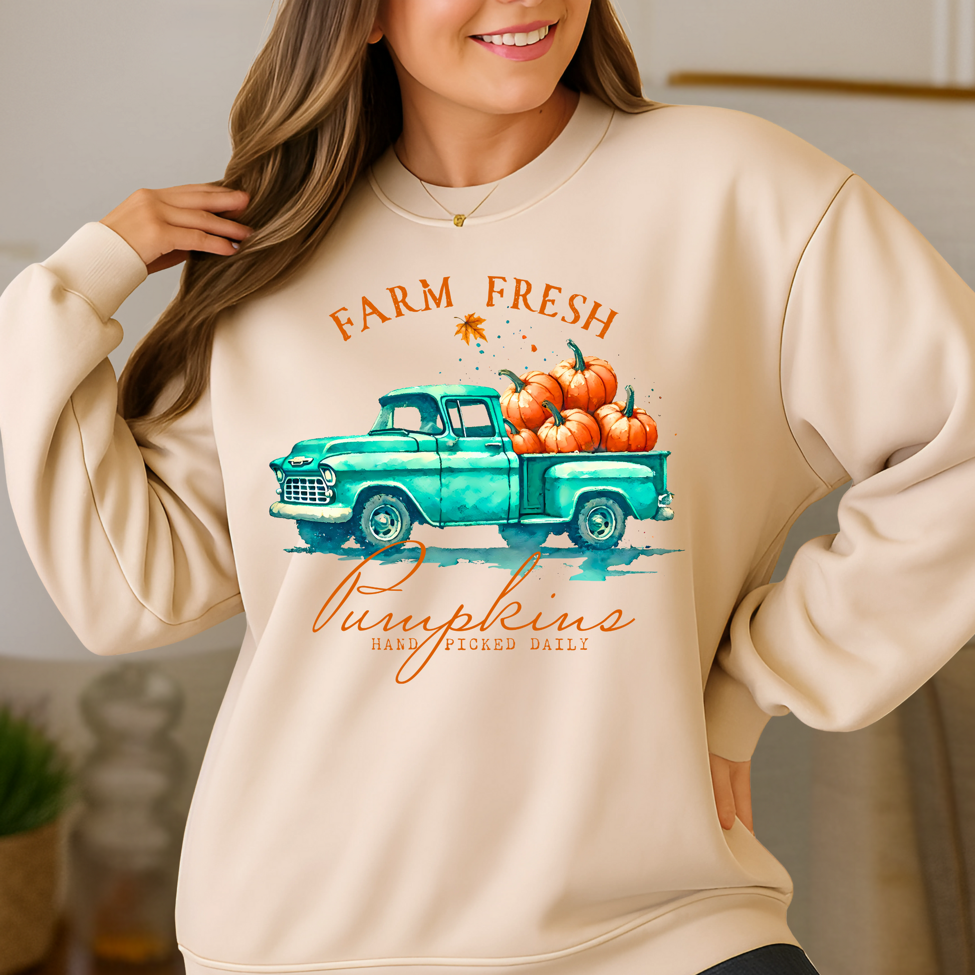 sand colored pumpkin patch sweatshirt modeled in a fall harvest setting