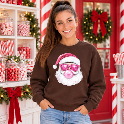 Woman wearing a brown Bubblegum Santa crewneck sweatshirt in a Christmas candy shop with peppermint jars and wreath