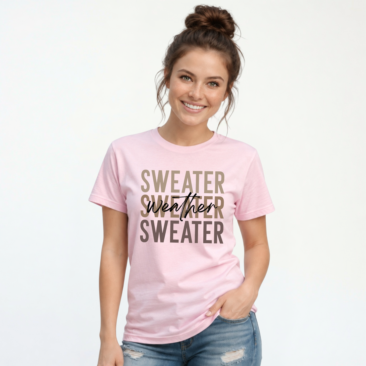 Woman wearing light pink Sweater Weather T-shirt with jeans