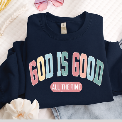 Navy blue sweatshirt with 'GOD IS GOOD ALL THE TIME' text on a light background