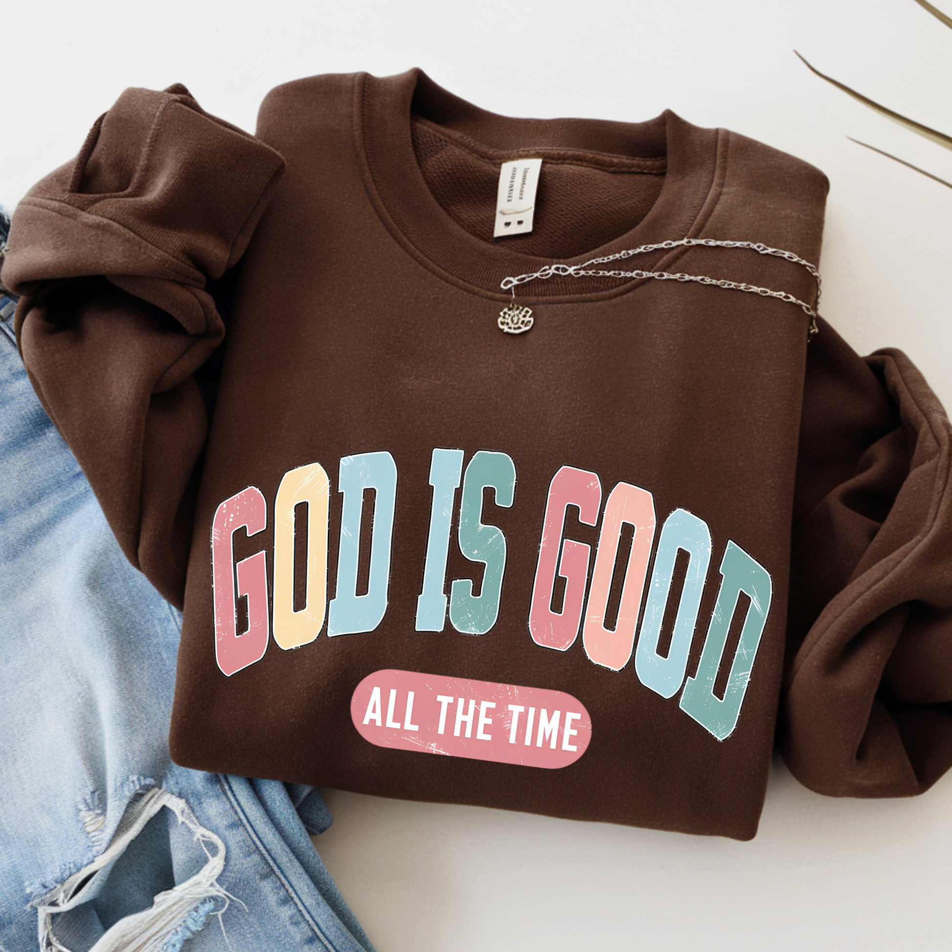 Brown sweatshirt with 'GOD IS GOOD ALL THE TIME' text on a white background