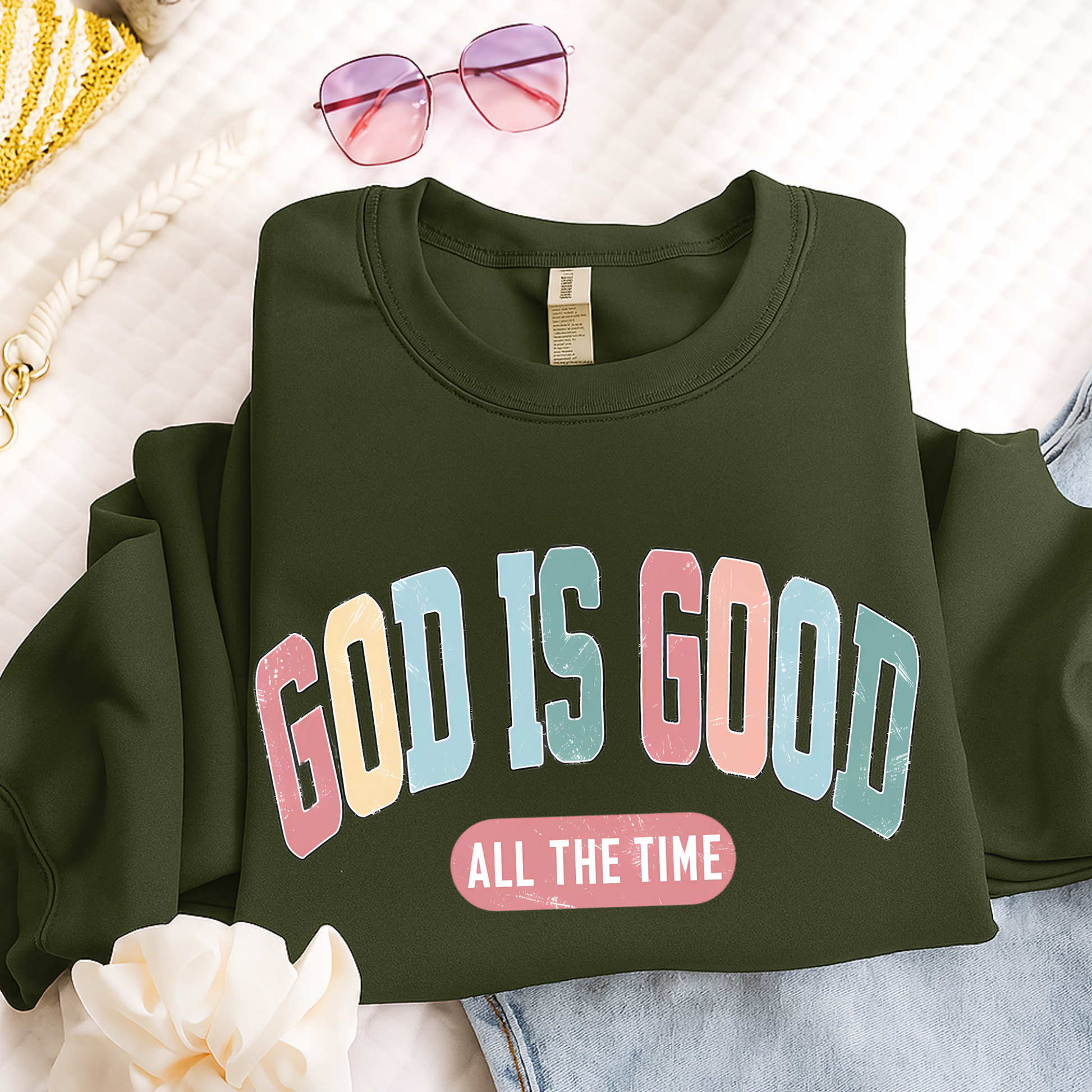 Green sweatshirt with 'GOD IS GOOD ALL THE TIME' text on a light background