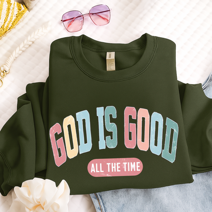 Green sweatshirt with 'GOD IS GOOD ALL THE TIME' text on a light background