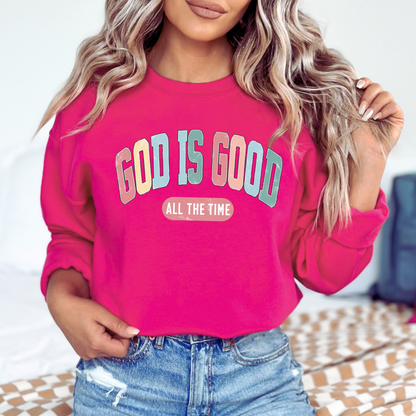 Person wearing a pink sweatshirt with 'God is Good All the Time' text.
