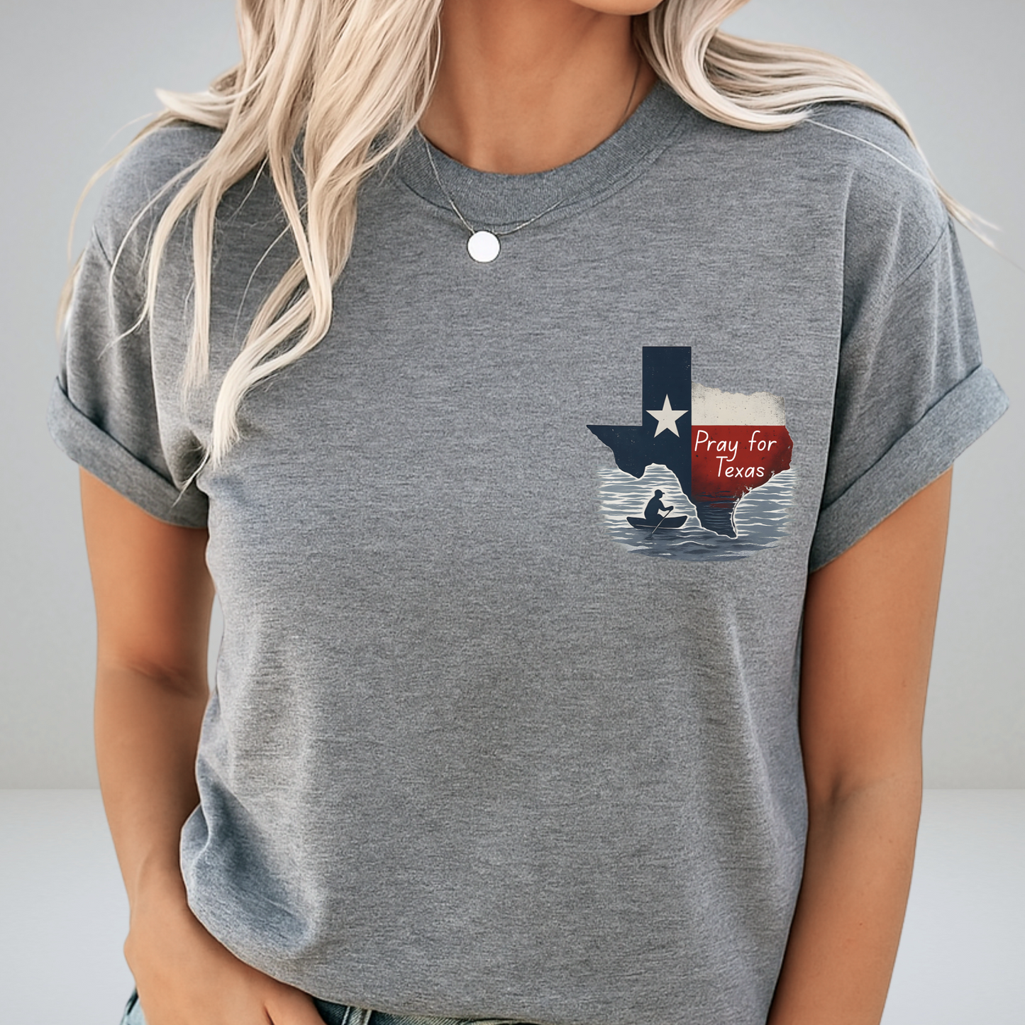 Person wearing a gray t-shirt with a graphic design of Texas and a red banner.