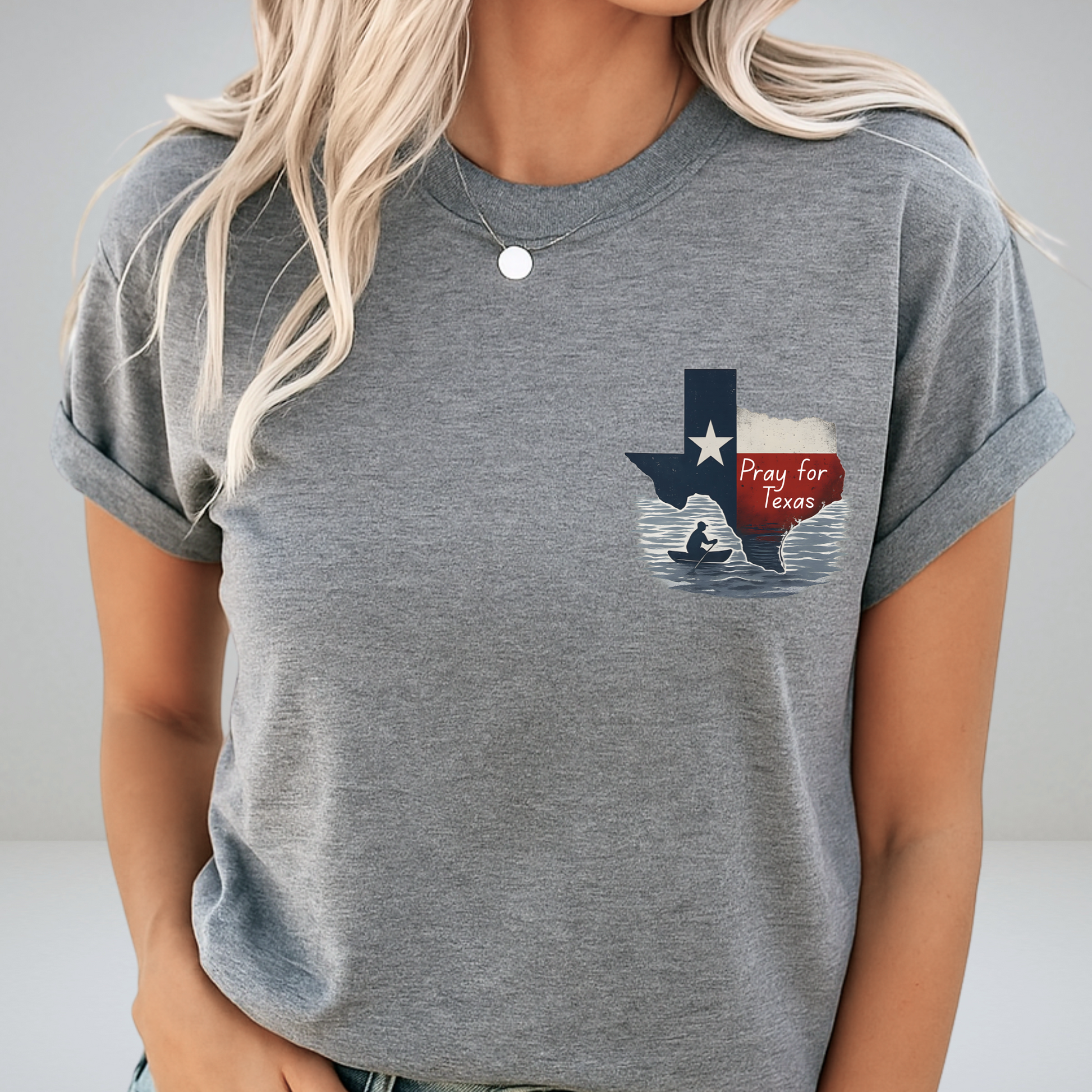 Person wearing a gray t-shirt with a graphic design of Texas and a red banner.
