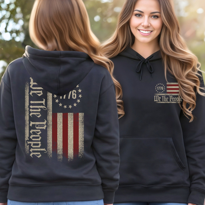Black hoodie with 'We The People' design on the front and back, worn by a woman outdoors.